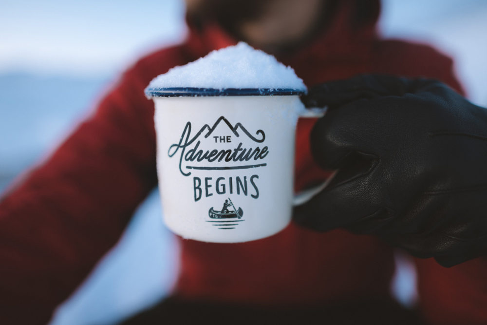 A cup that reads "Let the Adventure Begin"